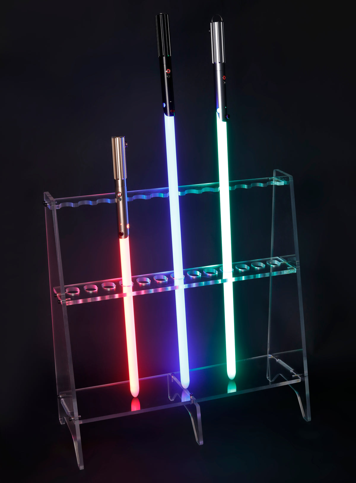 Clear multi-saber display rack holding three illuminated sabers